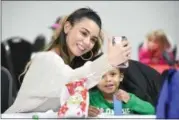  ?? ERIC BONZAR — THE MORNING JOURNAL ?? Merridith Figueroa takes a selfie with her 2-year-old son, Malachi, during Cookies &amp; Cocoa with Santa at Knights of St. John, 1620 Kansas Ave., Dec. 22