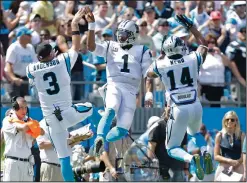  ??  ?? Carolina Panthers’ Cam Newton (1) celebrates his touchdown pass with Derek Anderson (3) and Joe Webb (14).