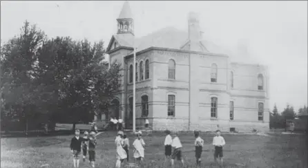  ?? RYCH MILLS COLLECTION ?? Ten of Ayr’s future citizens take a break from class around 1910 to mug for the camera. Ayr Public School is just 20 years old in this postcard view. Could the author’s grandmothe­r, Annie Idella Hawes, be one of the girls?