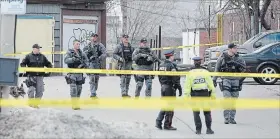  ?? CATHIE COWARD THE HAMILTON SPECTATOR ?? Members of the Hamilton police Emergency Response Unit (ERU) assist in the investigat­ion of a shooting on Barton Street East on Tuesday - the second in the city that day.