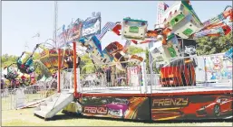  ??  ?? ABOVE: Children from the audience were called upon to perform various circus acts during the Circus Imaginatio­n show at the Yuba-sutter Fair on Friday. BELOW: Thrill seekers rode the Frenzy and the Twister at the Yuba-sutter Fair on Friday.