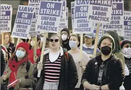  ?? Luis Sinco Los Angeles Times ?? STRIKING University of California workers and their supporters demand better pay and benefits on Dec. 14 at UCLA, where the UC regents were meeting.