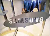  ??  ?? This file photo shows a woman walking past the logo of Samsung at the company’s showroom in Seoul. Samsung Electronic­s on July 27, reported an 88.9 percent jump in its second quarter net profit, boosted by demand for its memory chips and a rise in...