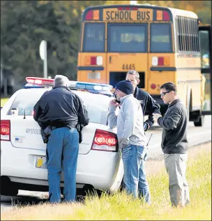  ?? SANTIAGO FLORES/AP PHOTOS ?? Emergency personnel respond to a scene of a collision where three children were killed Oct. 30 crossing State Route 25 as they were boarding their school bus north of Rochester.