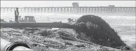  ?? EDUARDO CONTRERAS U-T FILE ?? Sand dredged from Oceanside Harbor flies out of a pipe along the beach just north of the Oceanside Municipal Pier in 2018. The harbor is dredged annually.