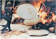  ?? RONALD L. HAEBERLE/ REPORT OF ARMY REVIEW INTO MY LAI INCIDENT, 1970 ?? A U.S. soldier burns a dwelling during the My Lai Massacre on March 16, 1968.