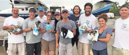  ??  ?? Kenny Chesney and friends — two-legged and four-legged — prepare to fly to the USA from the U.S. Virgin Islands as part of his Love For Love City mission to reunite rescued animals with their owners or offer them for adoption. LOVE FOR LOVE CITY FUND