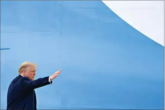  ??  ?? President Donald Trump waves from the top of the steps of Air Force One at Andrews Air Force Base on Friday in Maryland. Trump is heading to Florida to visit Southern Command, attend a roundtable event at a Doral church where he will speak with Cuban and Venezuelan dissidents and attend a fundraiser in Hillsboro Beach. (AP Photo/Susan Walsh)