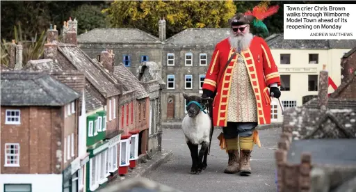  ?? ANDREW MATTHEWS ?? Town crier Chris Brown walks through Wimborne Model Town ahead of its reopening on Monday