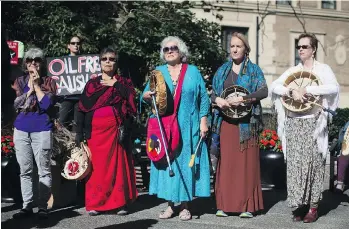 ?? DARRYL DYCK/THE CANADIAN PRESS ?? Women attend a rally on Monday outside Federal Court where a hearing about the Trans Mountain pipeline expansion is taking place. The hearing consolidat­es suits by seven First Nations, the cities of Burnaby and Vancouver, the Raincoast Conservati­on...