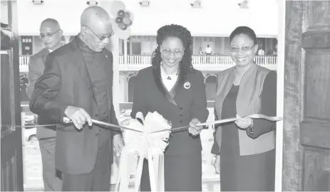  ??  ?? President David Granger assisting Chancellor of the Judiciary (ag) Justice Yonette Cummings-Edwards (at centre) and Chief Justice (ag) Roxane George-Wiltshire in the ceremonial ribbon-cutting for the new wing of the Georgetown High Court yesterday....