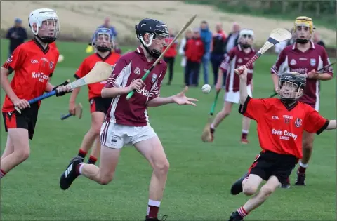  ??  ?? Nathan Roche (St. Martin’s) about to strike under pressure from J.D. Masterson and Frank Gallagher (Oulart-The Ballagh).