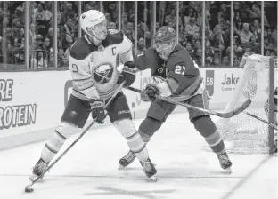  ?? ANDY MARLIN • USA TODAY SPORTS ?? Buffalo Sabres’ Jack Eichel skates with the puck as New York Islanders’ Anders Lee defends during NHL action on Saturday.