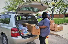  ?? COURTESY OF GLEANERS ?? Food is loaded into the back of a vehicle by an unidentifi­ed woman at a Gleaner’s facility.