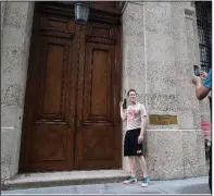  ?? AP/MARY ALTAFFER ?? A man poses for a photo Tuesday outside Jeffrey Epstein’s townhouse in Manhattan’s Upper East Side.