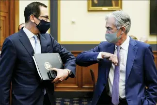  ?? JOSHUA ROBERTS — THE ASSOCIATED PRESS ?? Treasury Secretary Steven Mnuchin, left, greets Federal Reserve Chairman Jerome Powell before the start of a House Financial Services Committee hearing Tuesday on Capitol Hill about the government’s emergency economic aid in response to the coronaviru­s pandemic.