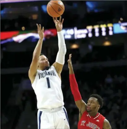  ?? LAURENCE KESTERSON — THE ASSOCIATED PRESS ?? Villanova guard Jalen Brunson shoots over St. John’s guard Shamorie Ponds early on Wednesday night Wells Fargo Center. Villanova was mostly cold from outside, a factor in a bad loss to the Red Storm. at