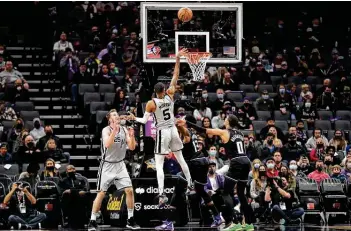  ?? Kavin Mistry / Getty Images ?? Dejounte Murray (5), putting up a floater against the Kings on Dec. 19, is expected to rejoin the Spurs for Wednesday’s game against the Celtics. Murray has missed the past five games after being in virus protocols.
