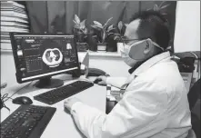  ?? PHOTOS PROVIDED TO CHINA DAILY ?? Left:A man walks past a non-contact remote temperatur­e screening system developed by SenseTime at Terminal 3 of the Beijing Capital Internatio­nal Airport. Right: A doctor analyzes images of suspected novel coronaviru­s cases with the help of AI-powered medical imaging evaluation system developed by Yitu Technology in Wuhan, capital of Hubei province, on Feb 5.