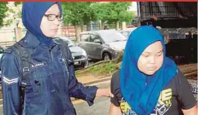  ??  ?? Mas Haini Mohd Zaini (right) arriving at the magistrate’s court in Butterwort­h yesterday.