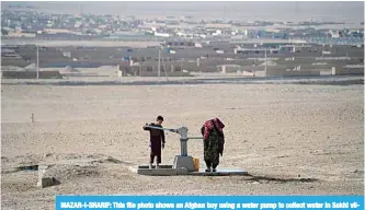  ??  ?? MAZAR-I-SHARIF: This file photo shows an Afghan boy using a water pump to collect water in Sakhi village on the outskirts of Mazar-i-Sharif. —AFP