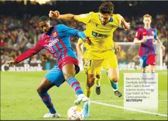  ?? REUTERSPIX ?? Barcelona’s Ousmane Dembele (left) in action with Cadiz’s Ruben Sobrino during the La Liga match at Nou Camp yesterday. –