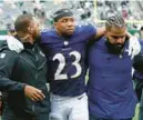  ?? JOHN MUNSON/AP ?? Ravens cornerback Kyle Fuller, center, tore his ACL in Sunday’s season opener against the New York Jets and will miss the rest of the season, coach John Harbaugh said Monday.