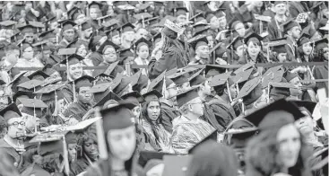  ?? Sam Hodgson / New York Times ?? City College of New York students attend their graduation ceremony in Manhattan last year. Navient is accused of misleading practices on student loans and illegally driving up costs for millions.