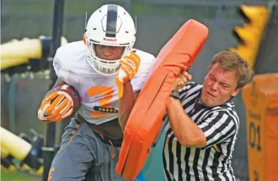  ?? THE ASSOCIATED PRESS ?? Tennessee running back Ty Chandler runs a drill Tuesday. Below is a rendering of the program’s practice fields from the school.