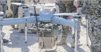  ??  ?? Marine Corps field users spent three weeks in March training to assemble, load, and fly each of the two systems – Chartis Federal’s MK4-rX (left) and survice Engineerin­g’s trV-150 (right) – being evaluated during the Field user Capability Assessment at Yuma proving Ground. (u.s. Marine Corps photo)