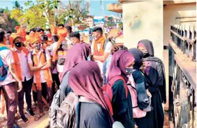  ?? ?? MUSLIM GIRLS wearing the hijab and Hindu students wearing saffron shawls to counter them outside MGM Pre University and MGM Degree colleges in Udupi on February 8, 2022.