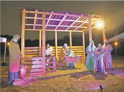  ?? PAUL W. GILLESPIE/CAPITAL GAZETTE PHOTOS ?? Joseph, Mary and Jesus are visited by three wise men at the Grace Pointe Community Church of the Nazarene living Nativity.