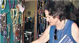  ??  ?? Juliette Leeb-du Toit examines some beadwork in the Hairy Canary Shop at Fort Nongqayi
