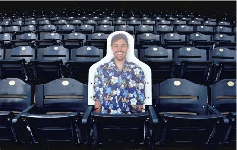  ?? ED ZURGA / GETTY ?? A cutout of a fan sits alone in the stands during the first day of workouts on July 3 at Kauffman Stadium in Kansas City, Missouri.