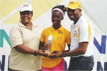  ??  ?? Winner, Girls 16 &amp; MOP, Omolayo Bamidele (middle) receiving from her trophy from Ogunjoye (left) and Ikhanna Mborah of the Sports Ministry at the end of the SNEPCO Junior Tennis Championsh­ip in Lagos…at the weekend.