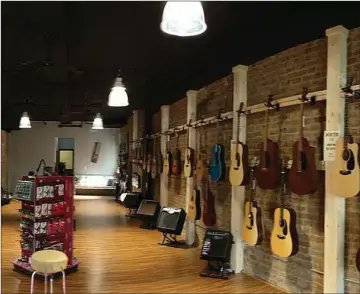  ?? Contribute­d photos / Rome News-Tribune ?? ABOVE: The walls of Broad Street Guitars, 338 Broad Street, are lined with “step up” guitars and accessorie­s.