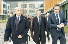  ?? — AFP ?? Right-wing candidate for the upcoming presidenti­al election François Fillon (centre) walks next to Bordeaux’s mayor Alain Juppe (left) and CEO of French multinatio­nal company Thales Patrice Caine (right), during a campaign visit at a plant of the...