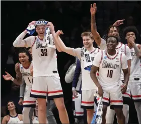  ?? MARY ALTAFFER — THE ASSOCIATED PRESS ?? Uconn players celebrate in the final seconds of Sunday’s win over Northweste­rn in New York.