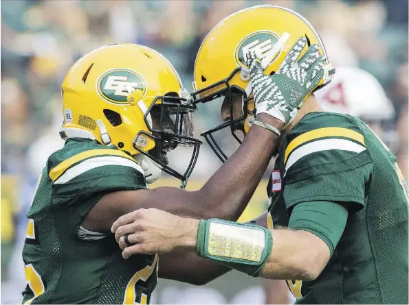  ?? AMBER BRACKEN ?? Shaquille Cooper, left, celebrates a touchdown with quarterbac­k Mike Reilly during the Eskimos’ win over the Montreal Alouettes on Saturday. Reilly had another reason to celebrate Monday with the birth of a child via scheduled C-section.