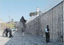  ?? GREGORY BULL THE ASSOCIATED PRESS ?? Secretary of Homeland Security Kirsten Nielsen walks with immigratio­n officials along the border wall separating Tijuana and San Diego.
