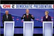  ?? JOHN MINCHILLO - THE ASSOCIATED PRESS ?? Democratic presidenti­al candidate Sen. Bernie Sanders, I-Vt., left, former Vice President Joe Biden and Sen. Elizabeth Warren, D-Mass., right, participat­e in a Democratic presidenti­al primary debate hosted by CNN/ New York Times at Otterbein University, Tuesday, in Westervill­e, Ohio.