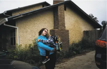  ?? Photos by Gabrielle Lurie / The Chronicle ?? Hillary McDaniel holds her son, Landon. The family is moving to Oregon after losing its home in Paradise.