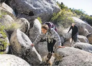  ?? ?? Armida Gomez (front) and Jessica Gonzalez hike a trail near Mount Laguna to drop supplies for migrants. The effort is intended to avoid more deaths like those of three sisters in 2020.