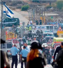  ?? AFP ?? Israeli security personnel gather at the site of the attack at the entrance to the West Bank settlement of Har Adar. —