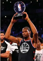  ??  ?? Team LeBron forward Kevin Durant of the Warriors celebrates being selected as MVP of the All-Star Game.