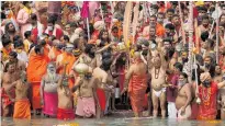  ??  ?? Hindu devotees gather to take holy dips in the Ganges River during Kumbh Mela in Uttarakhan­d, India.