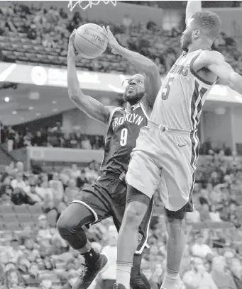  ?? ASSOCIATED PRESS ?? Brooklyn Nets forward DeMarre Carroll shoots against Memphis Grizzlies guard Andrew Harrison in the first half of an NBA basketball game in Memphis, Tenn.