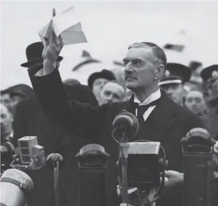  ?? PICTURE: GETTY ?? Neville Chamberlai­n promises ‘peace for our time’ on his return from the Munich Conference