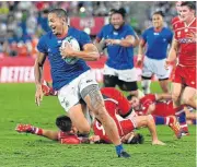  ?? /William West/AFP ?? Try delight: Samoa’s Ed Fidow runs in to score one of his two tries against Russia on Tuesday.