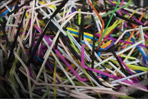  ?? Jasper Juinen/Bloomberg ?? Used flexible drinking straws sit in a bin at the Coca-Cola factory in Dongen, Netherland­s.